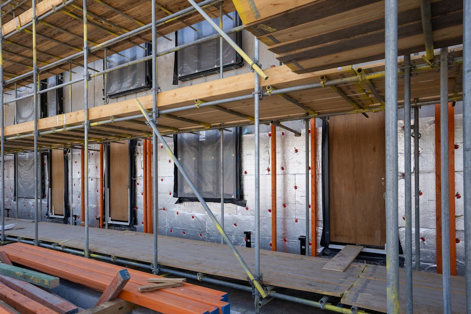 Contractor applying spray foam insulation in residential wall